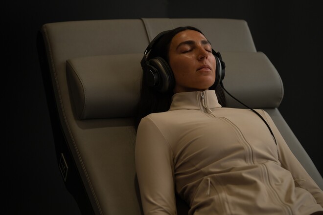 Member reclining fully clothed in the Zero G Lounge at Ultimate Longevity Center